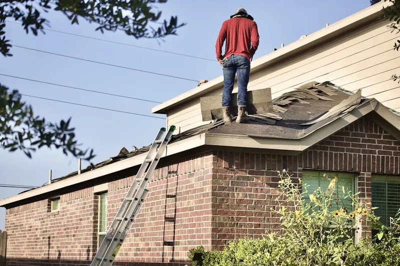 Professional roofer working on a residential roof in Chesterville